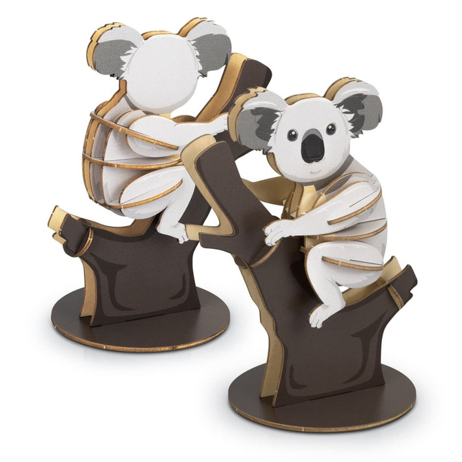 Two wooden koala models in white, grey, and brown, perched on a tree branch, showcasing a playful design.
