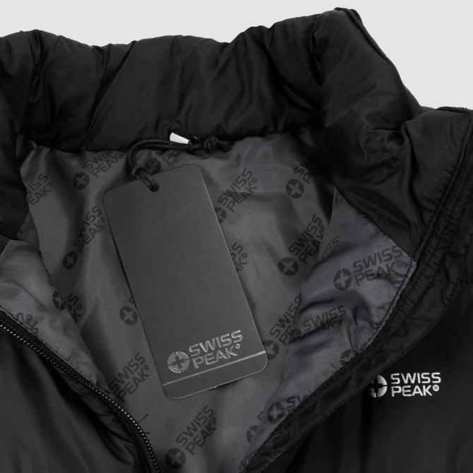 A black puffer vest with a high collar, featuring a tag and a subtle logo inside.