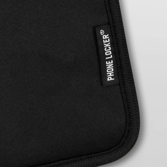 A black lockable phone pouch with a textured surface and a branding label.
