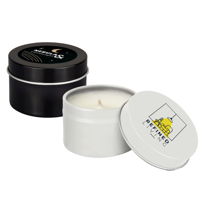 A set of two petite candles in tin containers, one black with a celestial design and the other white with a logo.