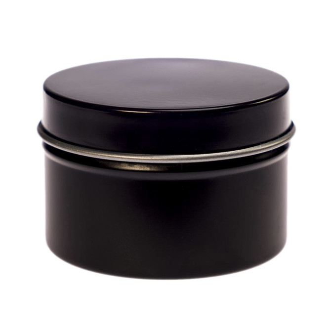 A petite black candle in a tin container with a smooth lid. The minimalist design features a sleek finish.