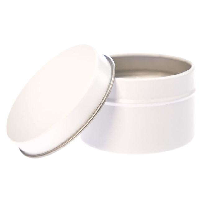 A petite candle in a white tin container with a removable lid.