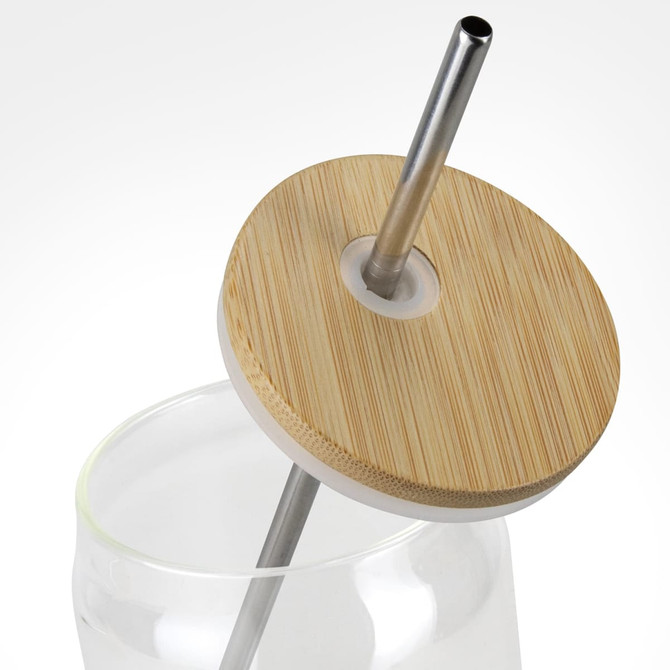 A glass tumbler with a bamboo lid and metal straw. The tumbler is partially filled with water.