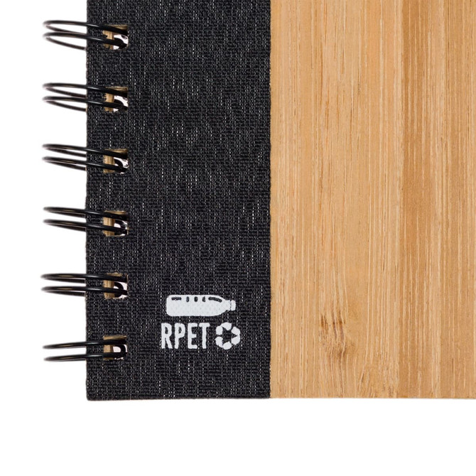 A black and bamboo spiral A5 notebook featuring a textured cover and a logo.