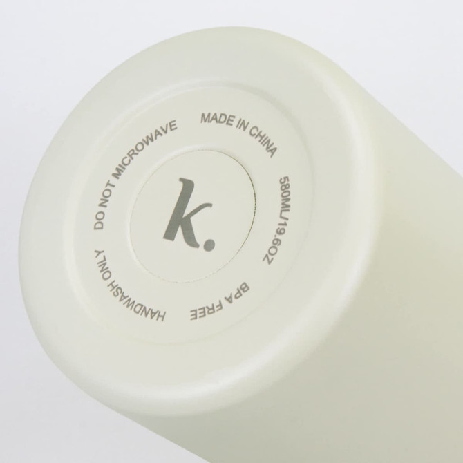 A drink bottle in a soft cream colour with a round base featuring a logo and care instructions.