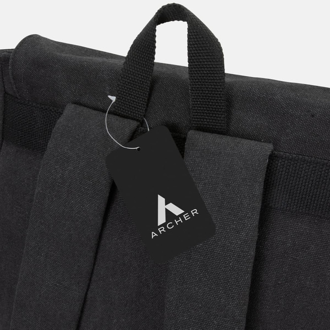 A black canvas backpack featuring a top handle and adjustable straps, with a branded tag attached.