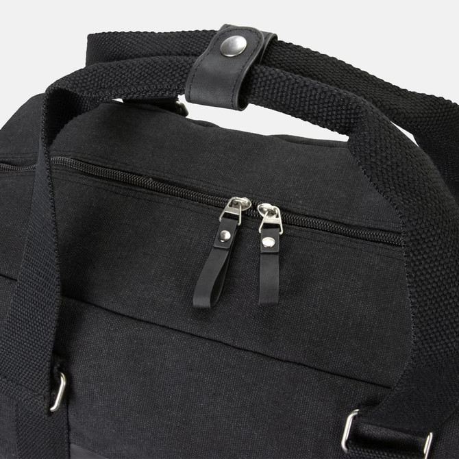 A black canvas duffle bag featuring sturdy handles and a zippered compartment. It has a branding logo.