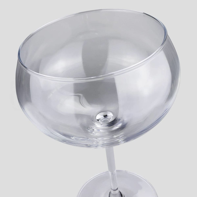 A Jenever gin glass with a clear, round bowl and a slender stem, featuring a simple design.