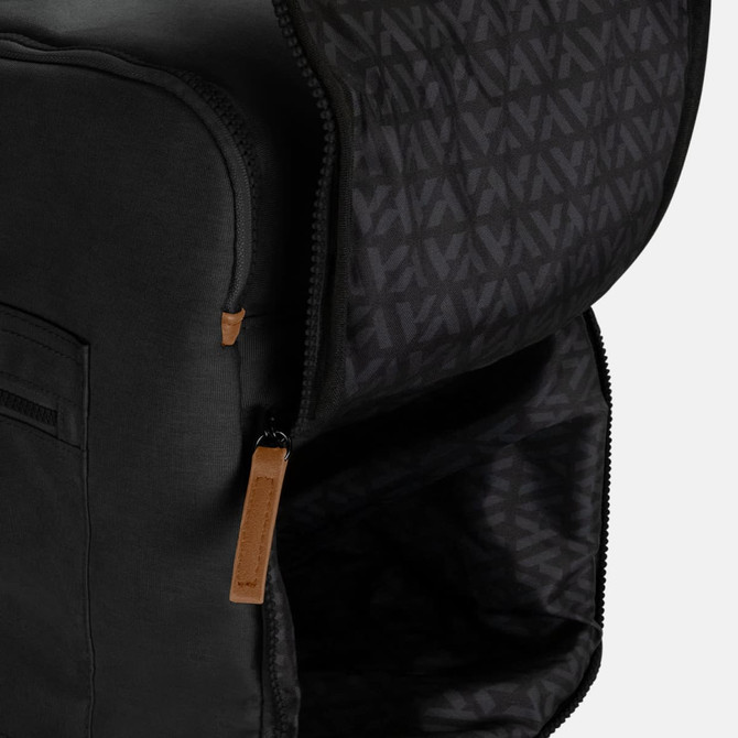 A black duffle bag with a zipped opening and a patterned interior, featuring a small leather tag.