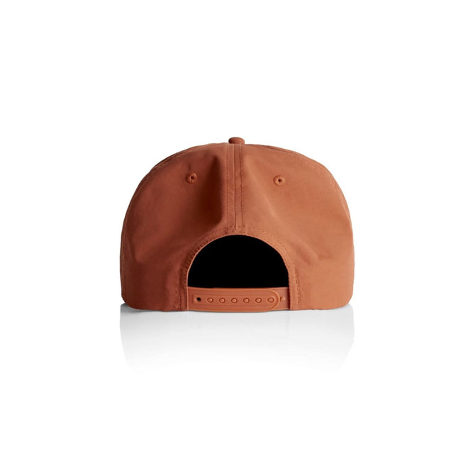 A rust-coloured cap with an adjustable strap and a logo on the back. The cap features a flat brim design.