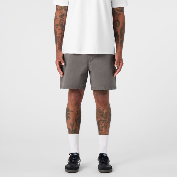 A pair of grey dress shorts featuring a simple design and a logo, modelled by a person with tattoos.