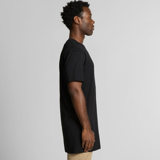 A side view of a black Tall Tee t-shirt, showcased on a model with short, curly hair. The shirt has a relaxed fit.