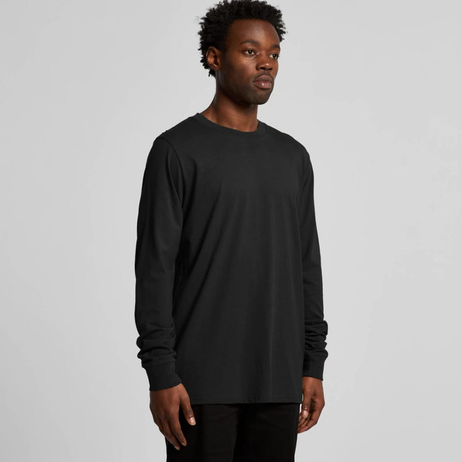 A long-sleeved black T-shirt on a model, featuring a simple design and a subtle logo.