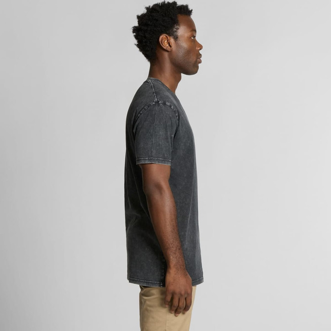 A man wearing a charcoal grey stone wash t-shirt stands in profile, showcasing the shirt's fit and style.