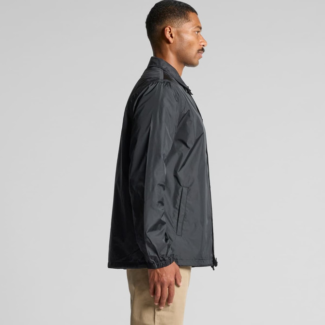 A black Coach Jacket is displayed on a model, featuring a simple design and a logo on the front.