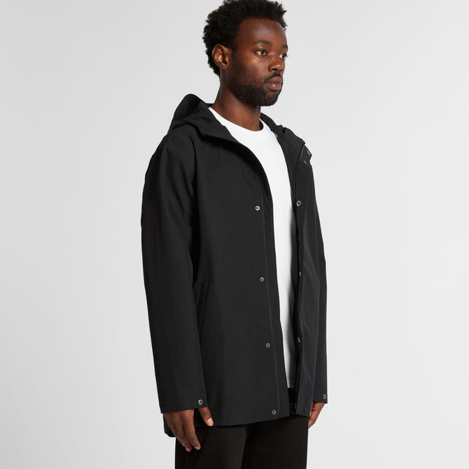 A black rain jacket with a hood, featuring a front zip and snap closures, displayed on a model.