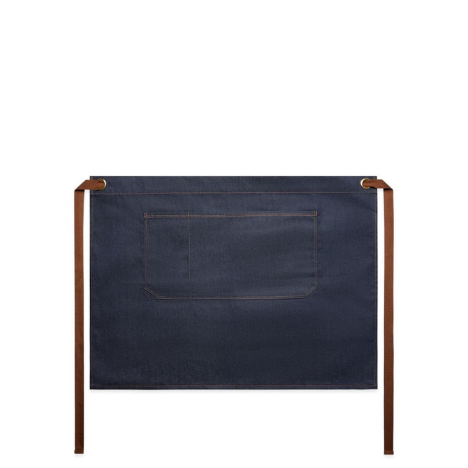 Denim half apron in dark blue with brown ties and a single pocket on the front, featuring a logo.