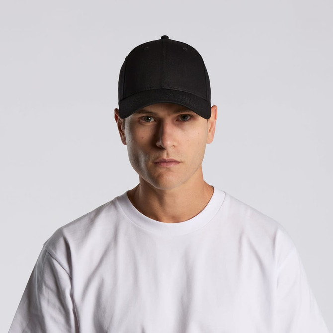 A black cap is worn by a model in a white T-shirt, featuring a logo on the front.