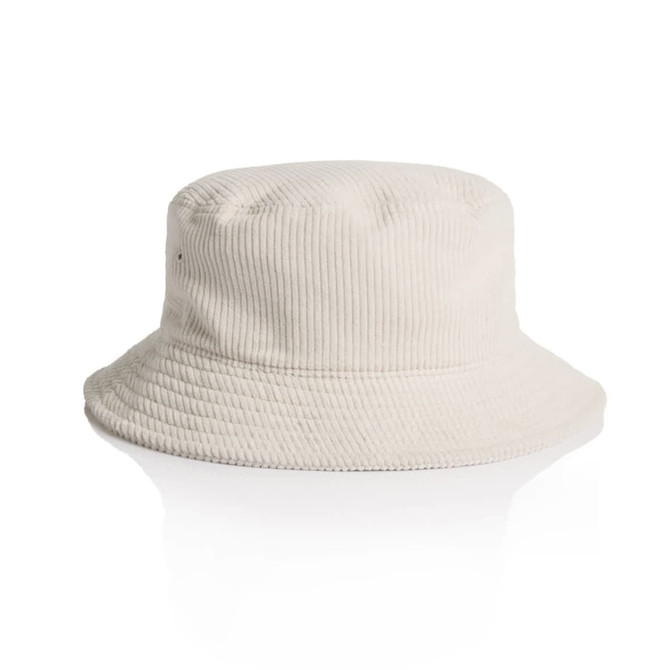 A cord bucket hat in a light beige colour with a wide brim and textured fabric. It features a logo.
