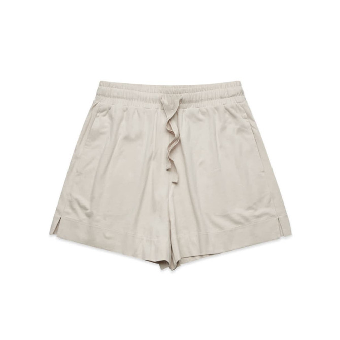 A pair of beige sports shorts with an elastic waist and side slits. The shorts have a logo on them.