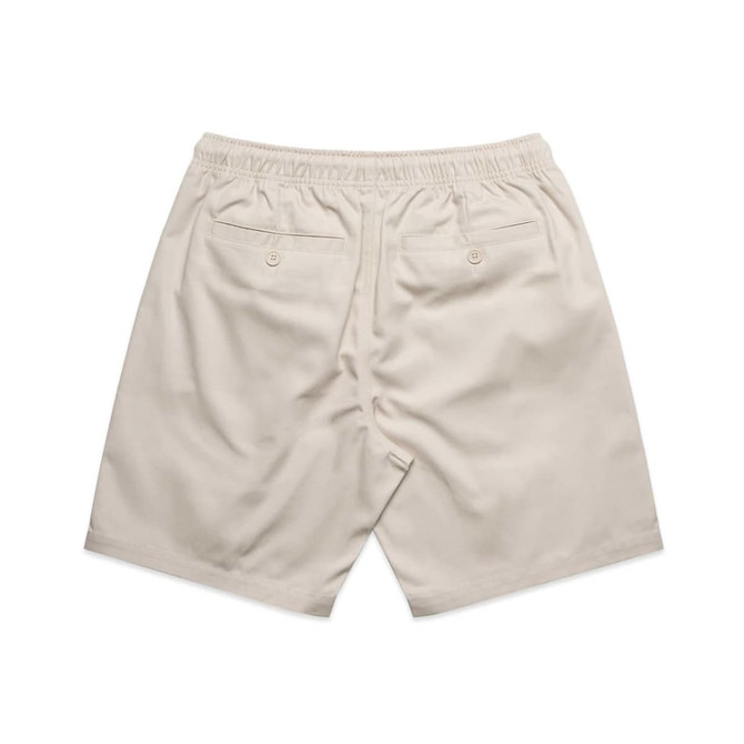 A pair of beige dress shorts with an elastic waistband and two back pockets, featuring a branding logo.
