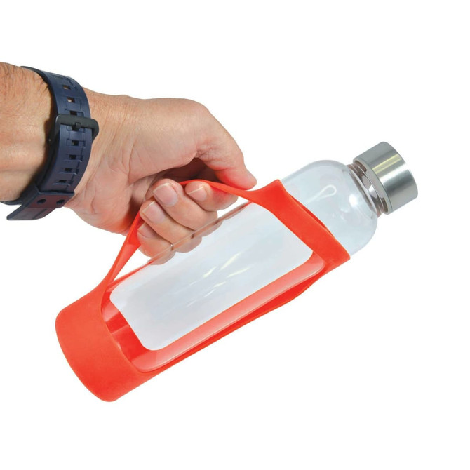 A drink bottle with a clear glass body and a bright red silicone sleeve, held by a hand. It has a metal cap.