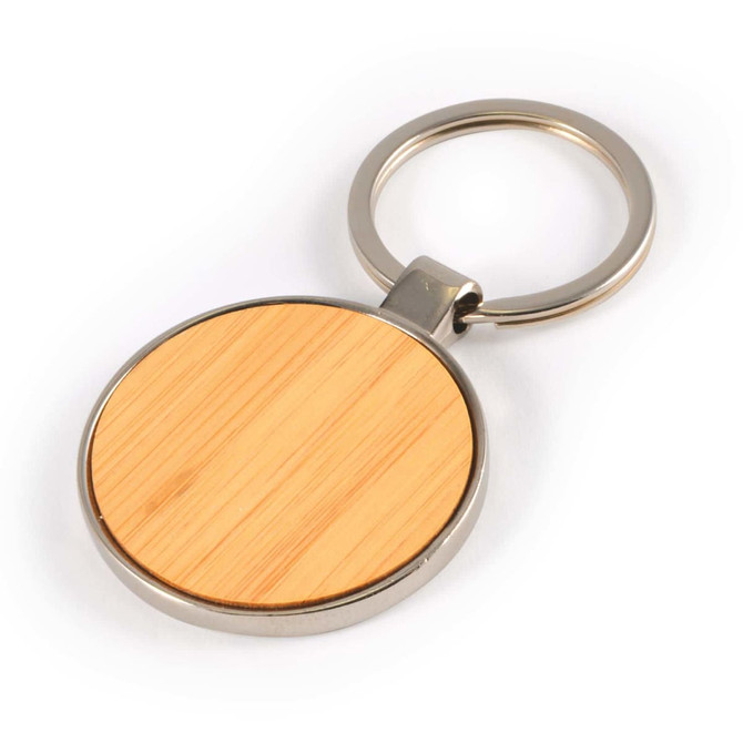 A circular bamboo and zinc keytag featuring a smooth bamboo surface and a metal keyring attachment.