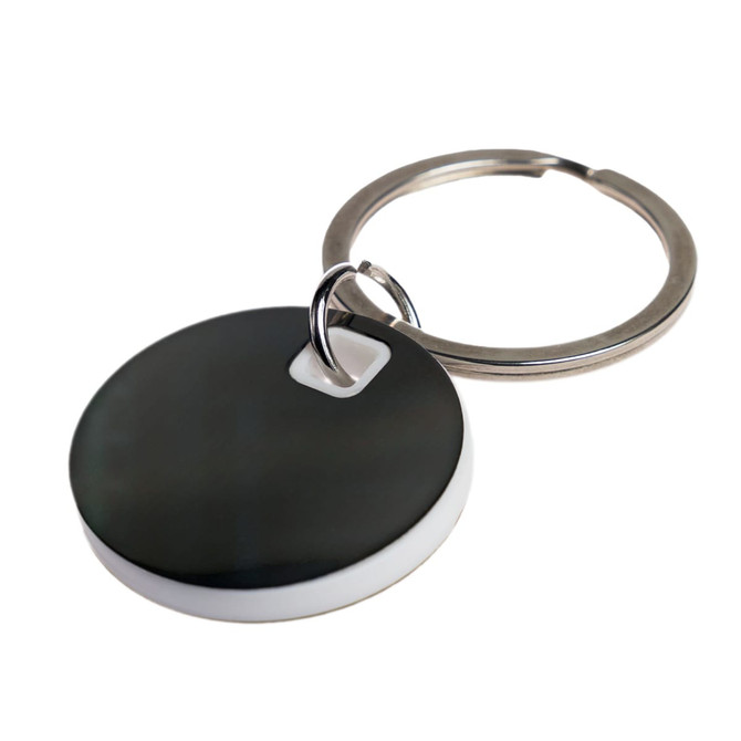 A circular stainless steel keytag featuring a black and white design, attached to a metal keyring.