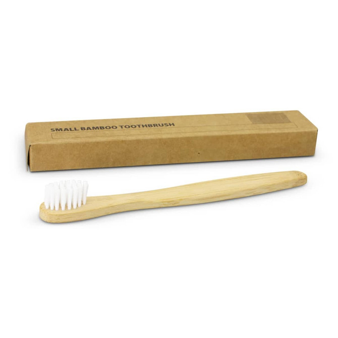 A bamboo toothbrush with a light wooden handle and white bristles, alongside a brown cardboard box.