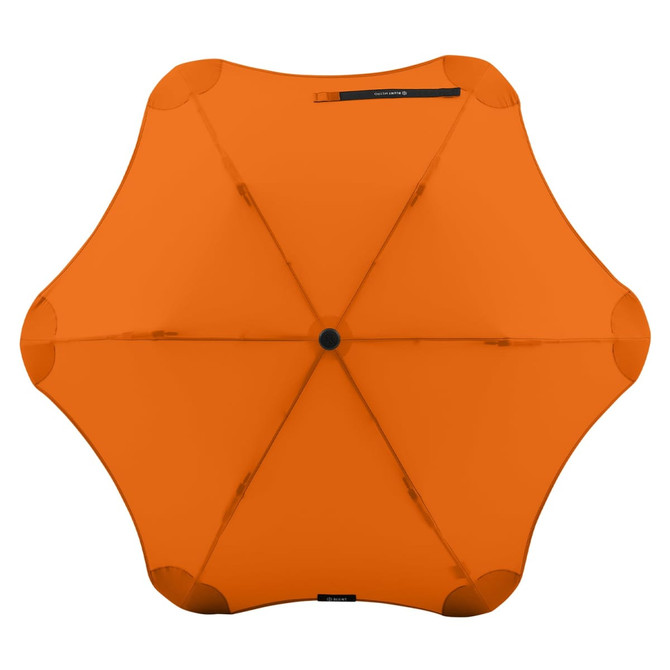 An orange BLUNT Metro Umbrella with an octagonal shape and a central button, featuring a logo.
