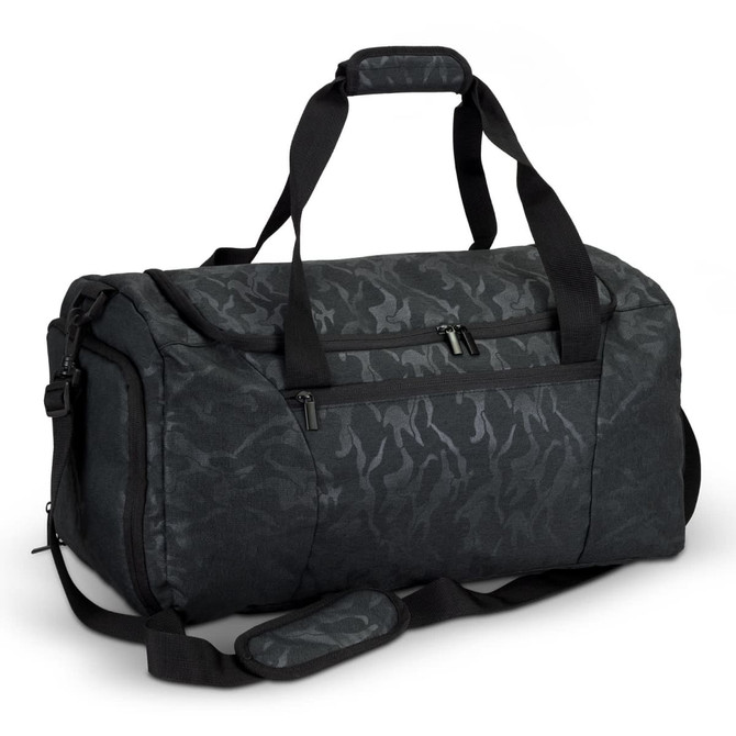 A black and dark grey camouflaged duffle bag with dual handles and an adjustable shoulder strap.