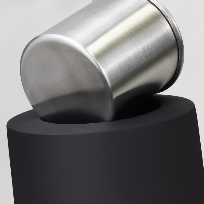 A stainless steel container with a matte black base, showcasing a sleek, modern design.