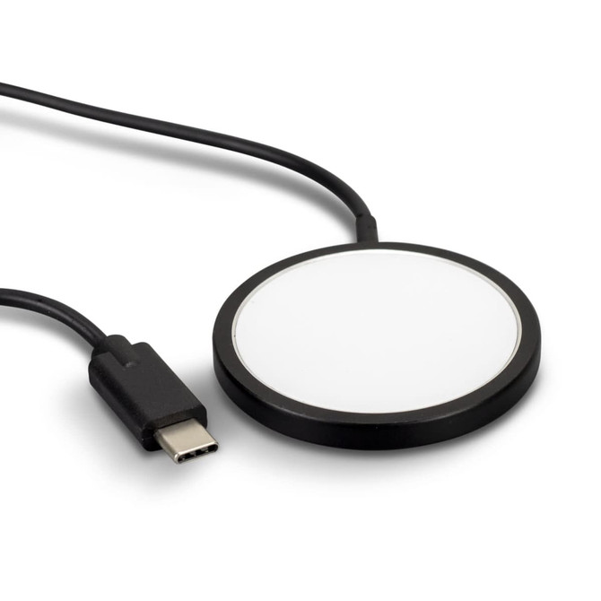A black wireless charger with a circular design and a connected USB-C cable.
