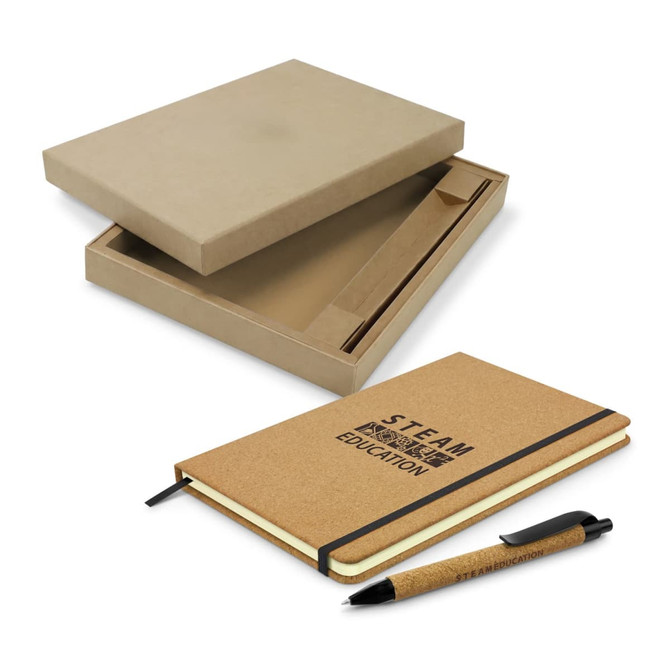 A brown cork notebook with an elastic band and a matching pen, presented in a cardboard box.
