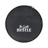 A round black bag with a zip, featuring a logo and the words "The Gentle Hustle" in white.