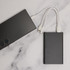 A sleek, black Octavius 4,000mAh Power Bank with multiple charging cables attached is displayed on a marble surface.