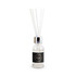 A vanilla reed diffuser in a transparent glass bottle with a black label and four white reeds.