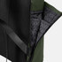 A soft-touch flap backpack in black and green, featuring a textured exterior and a patterned interior with pockets.