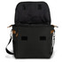 A black messenger bag with an open top, showing a patterned interior and tan detailing. It includes a shoulder strap and has a logo.