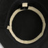 A black organic bucket hat featuring a light interior lining and a tag inside. Includes a logo.