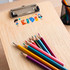 A wooden clipboard with a colourful logo and a set of vibrant coloured pencils arranged beside it.