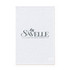A white cotton tea towel with a logo and a simple design featuring a leafy branch.