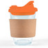 A reusable coffee cup featuring a transparent glass body, an orange snap lid, and a cork band for insulation.
