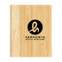 A wooden bamboo cover notebook featuring a circular logo with stylized lettering in black.
