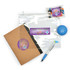A clear zipper pouch, a brown notebook, a blue stress ball, and a pen, along with a packet of colorful candies.