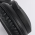 Black headphones with cushioned ear pads and a sleek design, featuring a branding logo on the side.