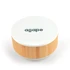 A round speaker and wireless charger with a white top and bamboo base, featuring a logo on the surface.