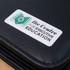 A black folder with a rectangular resin-coated label featuring a logo and text for an education centre.