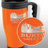 An orange travel mug with a black lid and handle, featuring a logo and mountain design.