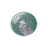 A 58mm round button badge with a green background and a graphic design featuring a ship and abstract lines.